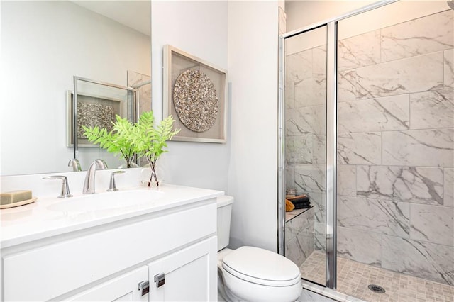 full bathroom with vanity, toilet, and a stall shower