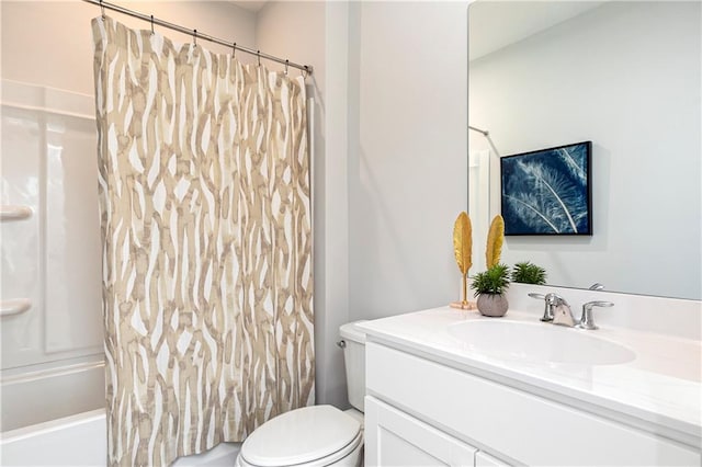 bathroom featuring vanity, shower / tub combo, and toilet