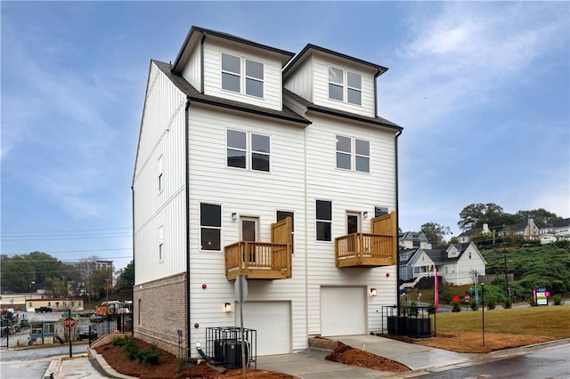 townhome / multi-family property featuring a garage, brick siding, and cooling unit