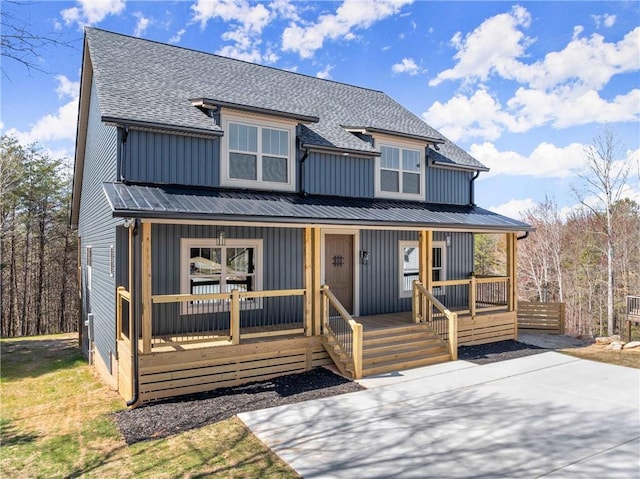 view of front facade featuring board and batten siding, a porch, and a shingled roof