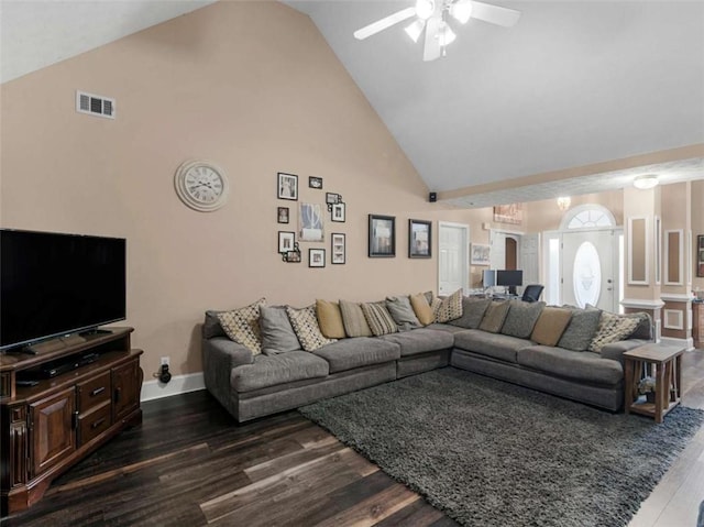 living room featuring dark wood-type flooring, ceiling fan, and high vaulted ceiling