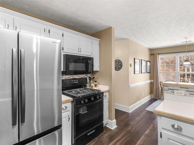 kitchen featuring white cabinets, decorative light fixtures, dark hardwood / wood-style flooring, and black appliances