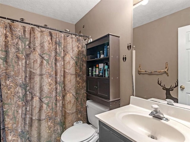 bathroom with vanity, a textured ceiling, and toilet