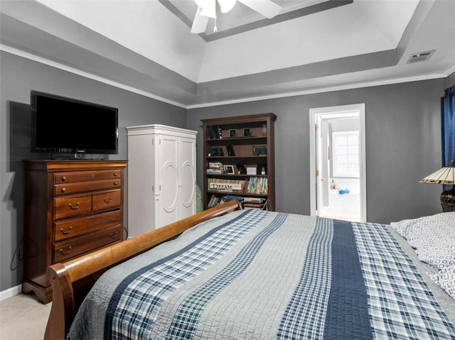 bedroom featuring a tray ceiling, crown molding, ceiling fan, and carpet