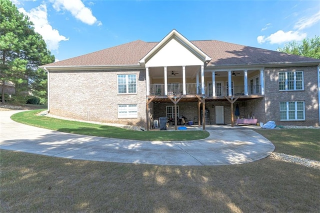 exterior space featuring a patio area, a balcony, and a front yard