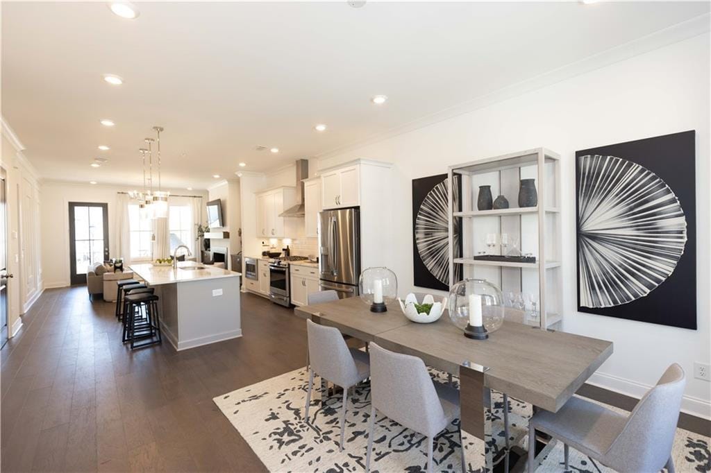 dining room featuring baseboards, dark wood finished floors, and recessed lighting