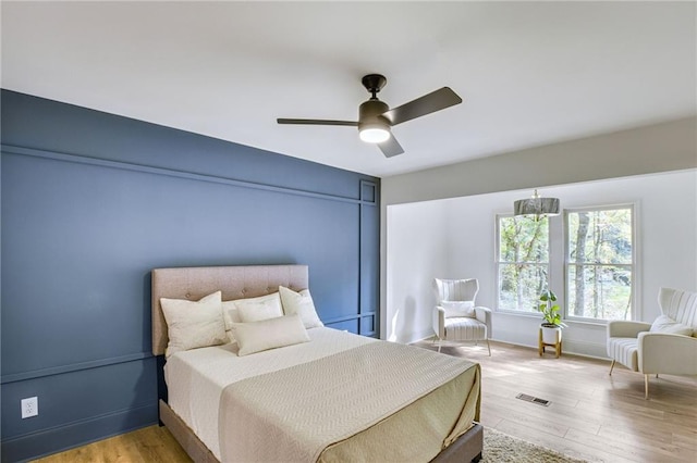 bedroom featuring hardwood / wood-style floors and ceiling fan