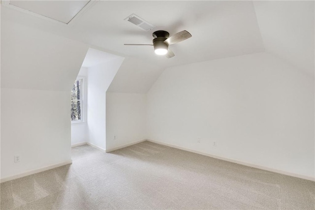 bonus room with lofted ceiling, light carpet, and ceiling fan