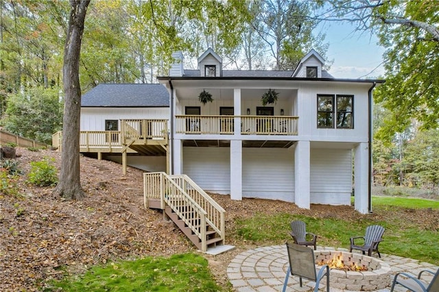 back of property featuring a patio and an outdoor fire pit