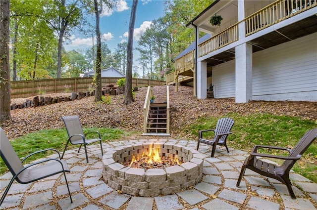 view of patio with an outdoor fire pit and a wooden deck