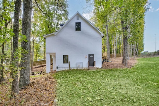 back of house with a lawn