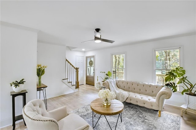 living room featuring a wealth of natural light, ceiling fan, and light hardwood / wood-style floors