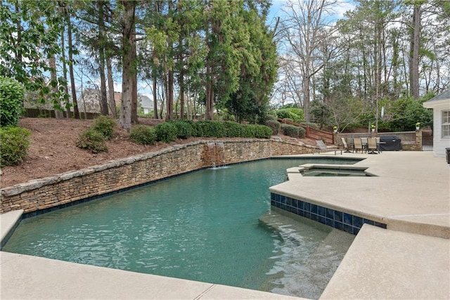 view of swimming pool featuring a patio and an in ground hot tub