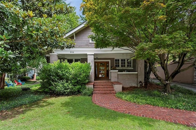 view of front of house with brick siding and a front lawn