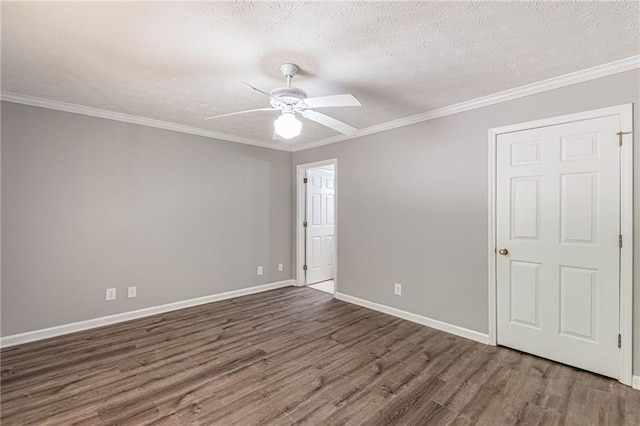 spare room featuring crown molding, a textured ceiling, dark hardwood / wood-style flooring, and ceiling fan