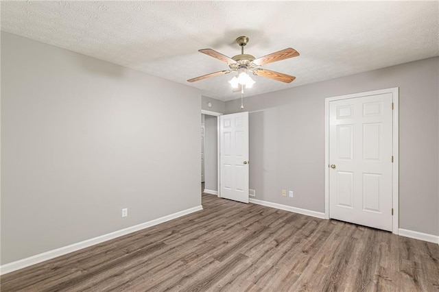 spare room featuring hardwood / wood-style floors, a textured ceiling, and ceiling fan