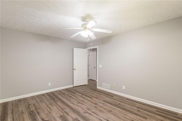 spare room featuring a textured ceiling, hardwood / wood-style flooring, and ceiling fan