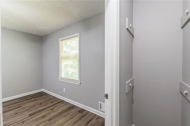 interior space with hardwood / wood-style floors and a textured ceiling