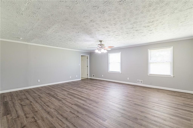 unfurnished room featuring ceiling fan, crown molding, a textured ceiling, and dark hardwood / wood-style flooring