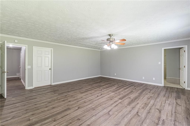 empty room featuring ceiling fan, hardwood / wood-style flooring, and ornamental molding