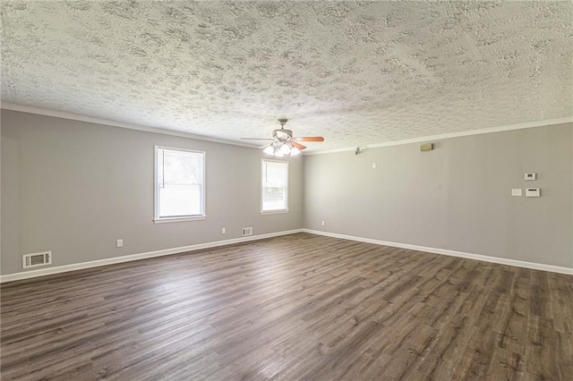 empty room featuring ceiling fan, a textured ceiling, dark hardwood / wood-style flooring, and ornamental molding