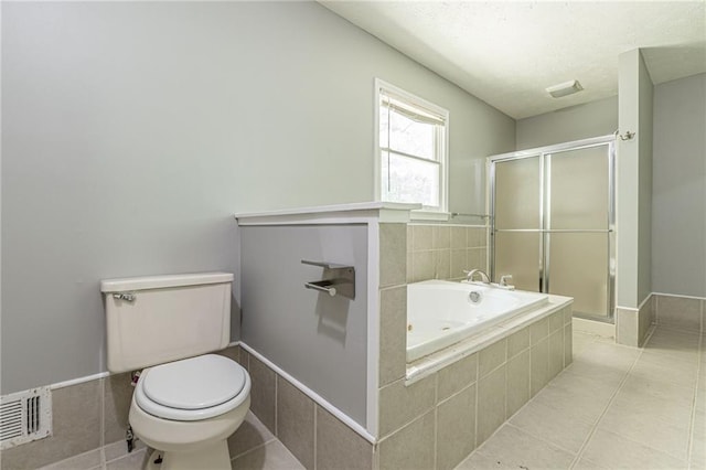 bathroom with toilet, tile patterned flooring, and plus walk in shower