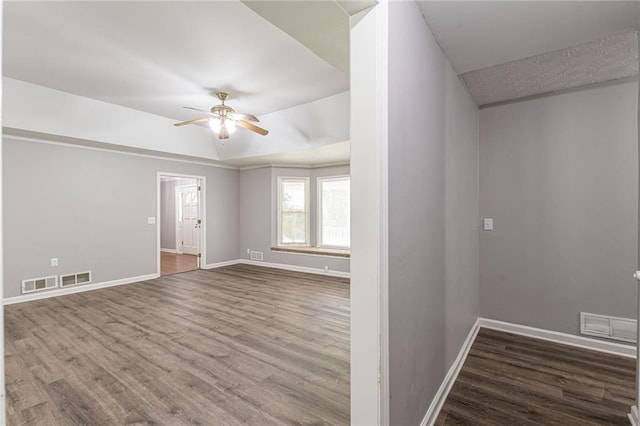 unfurnished room featuring hardwood / wood-style floors and ceiling fan