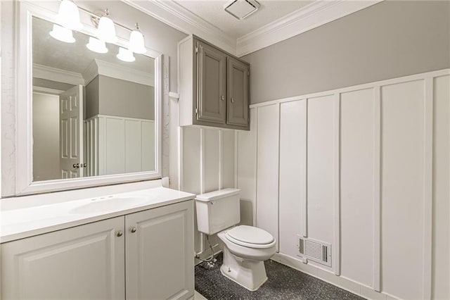 bathroom featuring toilet, ornamental molding, and vanity