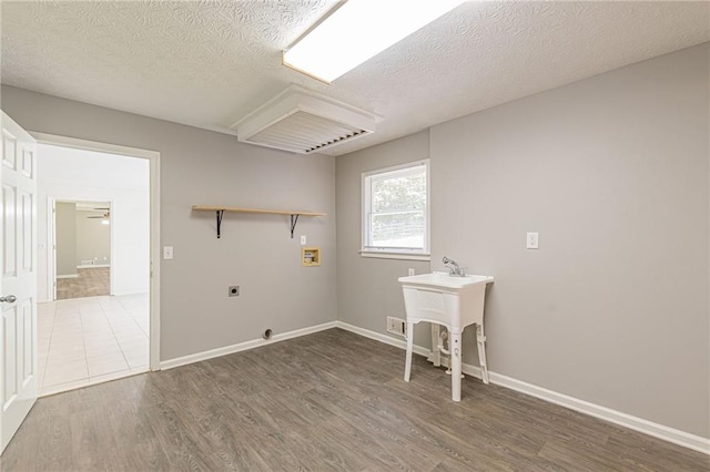 laundry area featuring hookup for a washing machine, hookup for an electric dryer, a textured ceiling, ceiling fan, and dark wood-type flooring