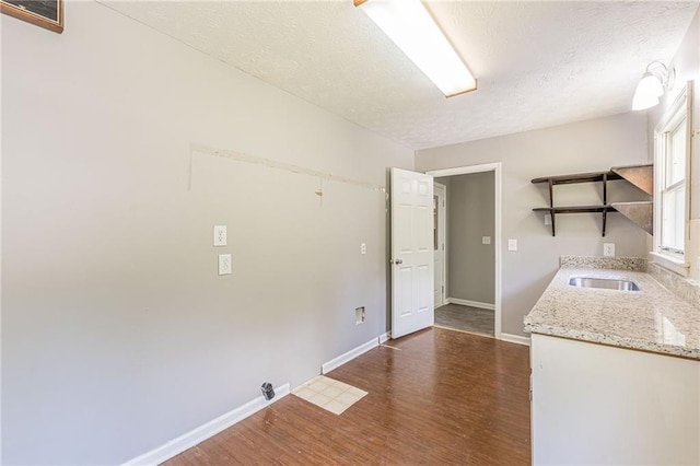 interior space with sink, a textured ceiling, and dark hardwood / wood-style floors