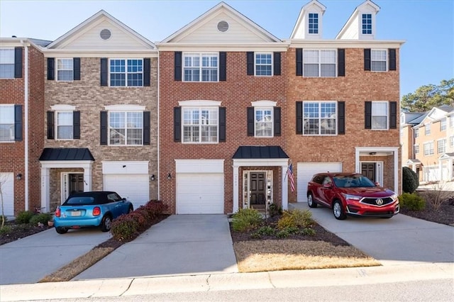 townhome / multi-family property featuring driveway, a garage, and brick siding