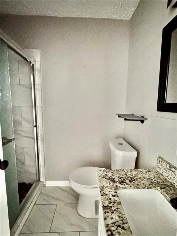 312 E Broad St, Winder, GA 30680 - full bath featuring toilet, vanity, marble look tiles, and a stall shower