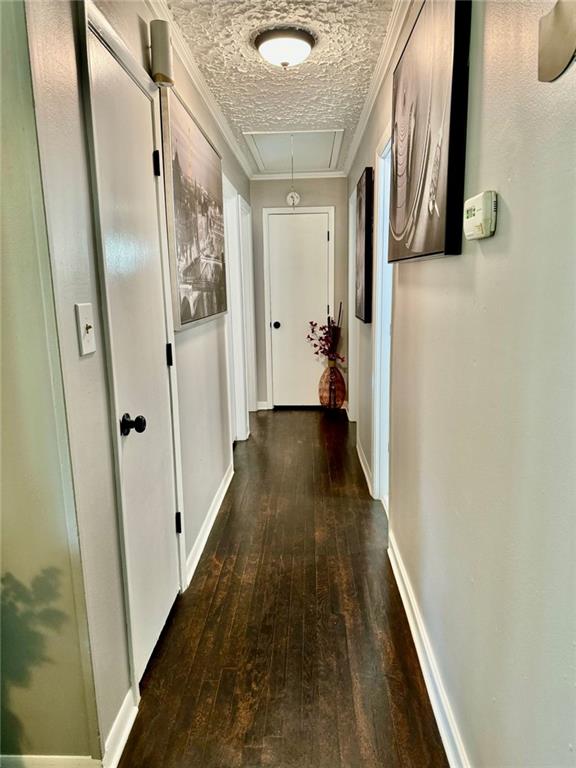 312 E Broad St, Winder, GA 30680 - hallway featuring attic access, wood-type flooring, ornamental molding, and baseboards