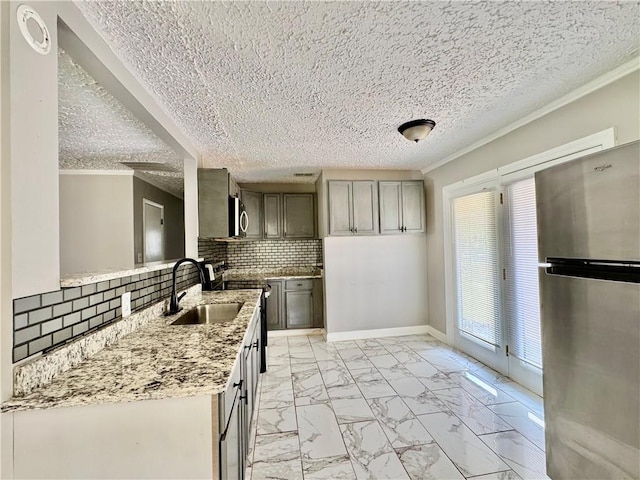 312 E Broad St, Winder, GA 30680 - kitchen with appliances with stainless steel finishes, a sink, light marble finish flooring, crown molding, and decorative backsplash