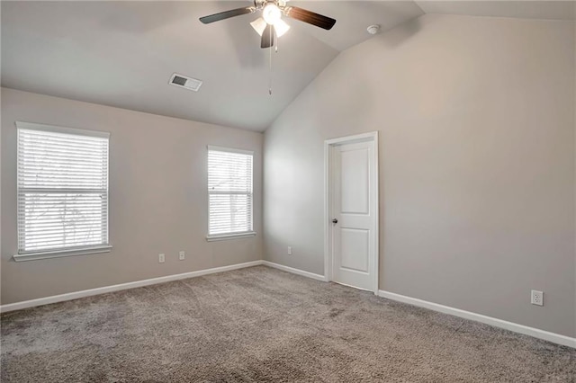 unfurnished room with ceiling fan, light colored carpet, lofted ceiling, and plenty of natural light