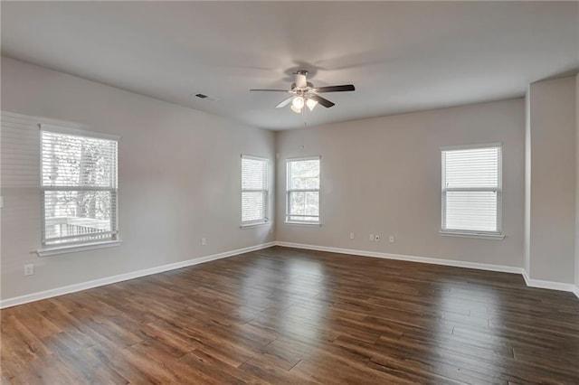 empty room featuring dark hardwood / wood-style flooring and ceiling fan