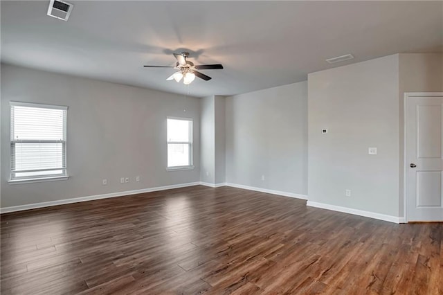 unfurnished room with dark wood-type flooring and ceiling fan