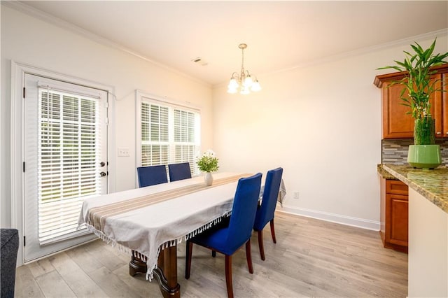 1076 Scenic Park Trl, Lawrenceville, GA 30046 - dining space with a chandelier, ornamental molding, light wood finished floors, and baseboards