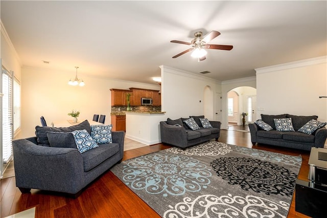 1076 Scenic Park Trl, Lawrenceville, GA 30046 - living room with arched walkways, ornamental molding, plenty of natural light, wood finished floors, and a chandelier