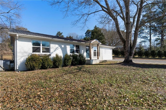 ranch-style house with central AC and a front yard