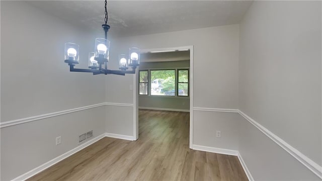 1102 Tony Valley Dr, Conyers, GA 30013 - empty room with wood finished floors and a chandelier