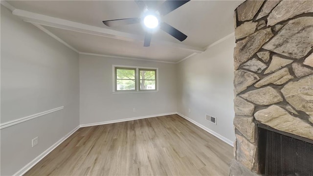 1102 Tony Valley Dr, Conyers, GA 30013 - unfurnished living room featuring ceiling fan, wood finished floors, a fireplace, ornamental molding, and beam ceiling