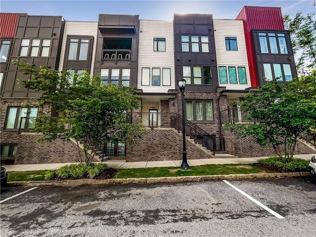 371 Pratt Dr SE Unit 203, Atlanta, GA 30315 - view of property with uncovered parking and stairs