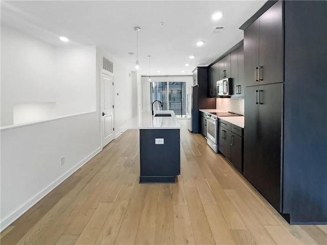 371 Pratt Dr SE Unit 203, Atlanta, GA 30315 - kitchen featuring a sink, stainless steel appliances, visible vents, light wood finished floors, and light countertops