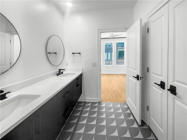 bathroom featuring ceiling fan, double sink vanity, and tile patterned flooring