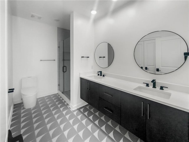 bathroom with tile patterned flooring, double sink vanity, an enclosed shower, and toilet