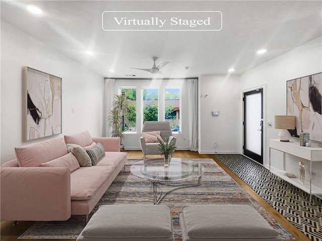 living room featuring ceiling fan and wood-type flooring