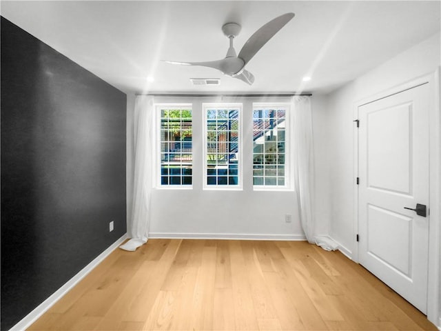 empty room featuring light hardwood / wood-style flooring and ceiling fan