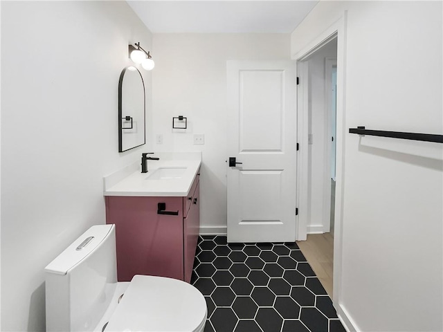 371 Pratt Dr SE Unit 203, Atlanta, GA 30315 - bathroom featuring tile patterned floors, toilet, baseboards, and vanity