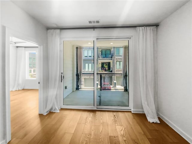 doorway with wood-type flooring